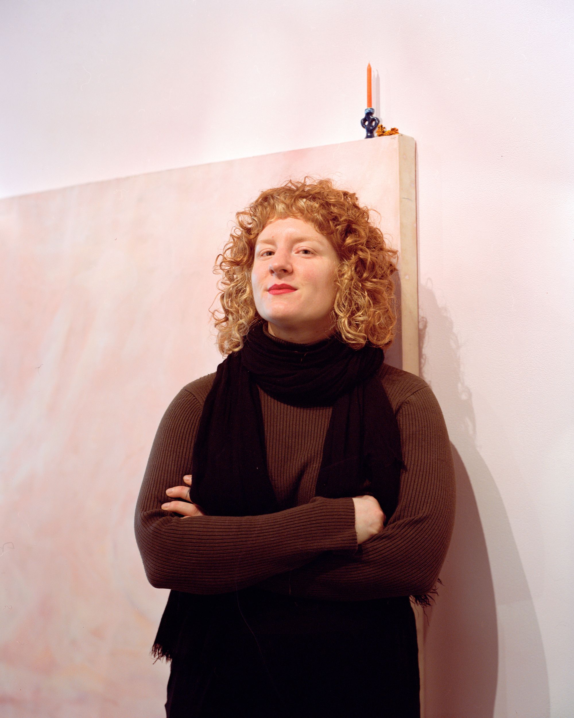 Portrait of Courtney Faulkner in front of their art.