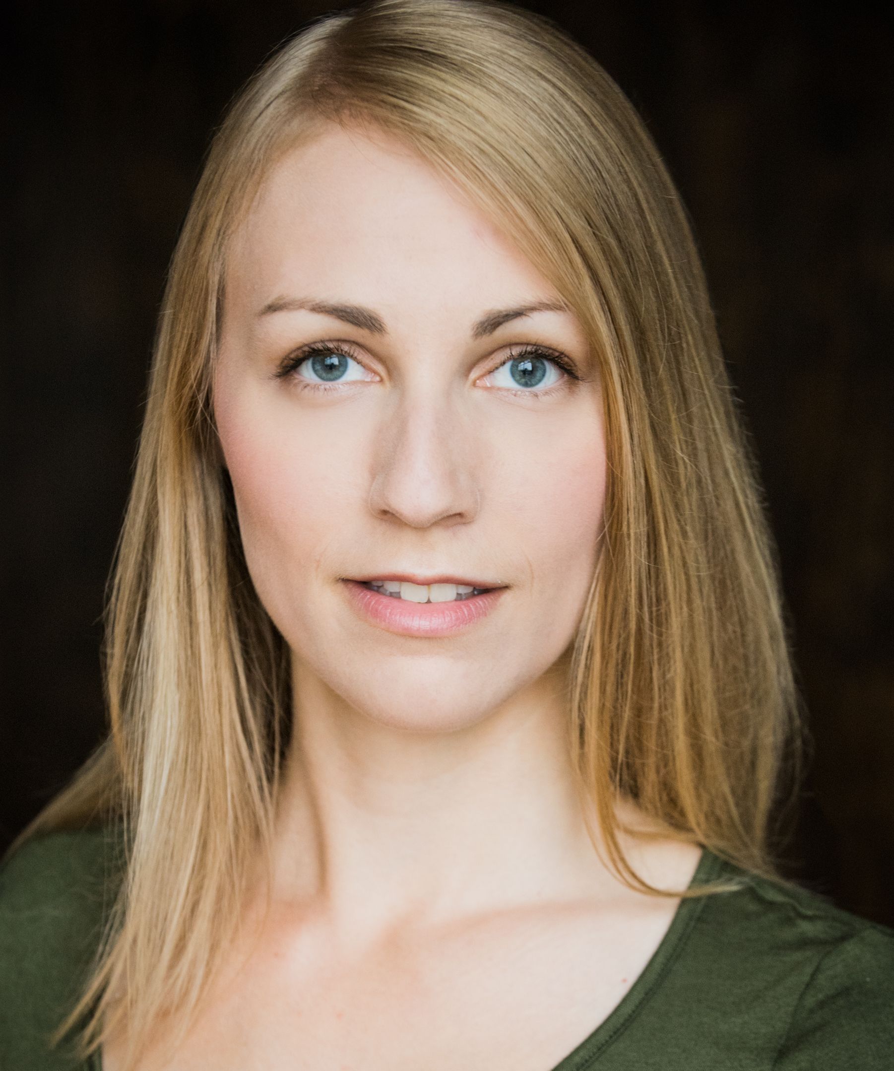 Chelsea Woolley wearing a green shirt with long, blonde hair.